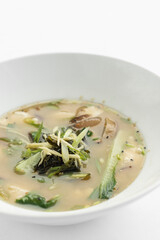 japanese miso soup with tofu, shiitake mushrooms, bok choy and seaweed