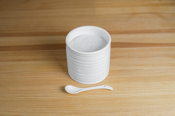 Kitchen set is sugar with a spoon on a wooden table