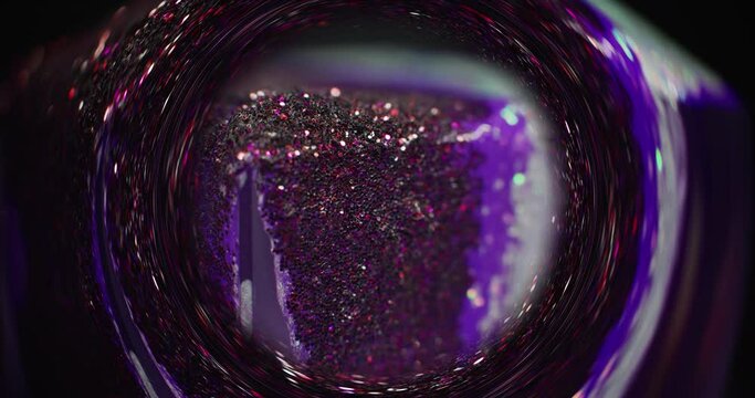 Glitter abstract background. Blur glow circle. Bokeh shiny sand. Purple pink color sparkling ink motion in defocused round whirl frame on dark black shot on RED Cinema camera.