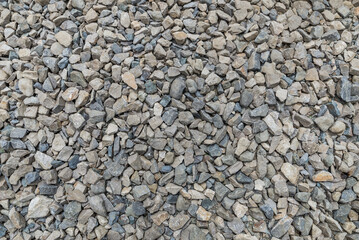 Smooth round pebbles texture background. Pebble sea beach close-up, dark wet pebble and gray dry pebble.