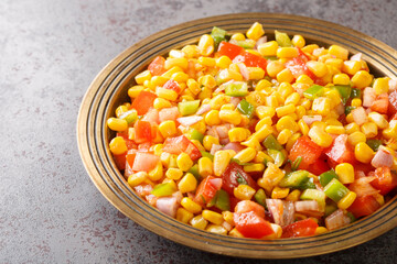 Sweet Corn Chat or Steamed yellow sweet corn, Chat Masala on a plate closeup in the table. Horizontal