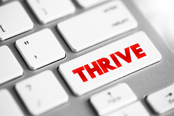 Thrive text button on keyboard, concept background
