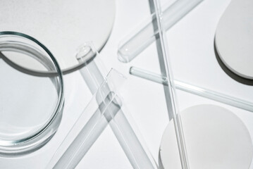 Test tubes, petri dish and glass rods in the laboratory on white background. Science research....