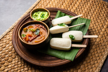 Idly lollipop or idli candy with stick served with sambar and chutney,South indian breakfast