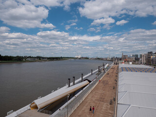 Landscape photo of the river Scheldt and the right bank of the city of Antwerp with famous buildings and the Port