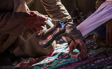Photo of traditional arabic tea pot and cup. Bedouin tea, traditional tea