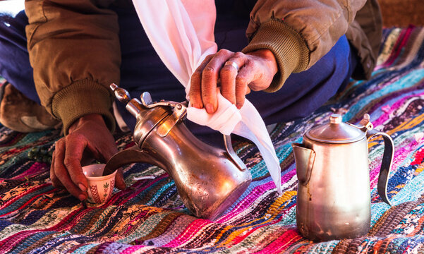 Photo of traditional arabic tea pot and cup. Bedouin tea, traditional tea