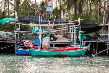 Fototapeta na wymiar small fishing boat that catches fish and squid along the coast in a traditional way and maintains an ecosystem of fish and marine life for a long time on strong and windy days.