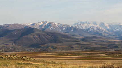 A stunning mountain landscape. Snow-covered mountains and yellow valleys. Zangezur Mountains. Armenia