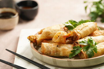 Traditional southeast asian starter dish spring or summer rolls - deep fried dim sum dumplings...