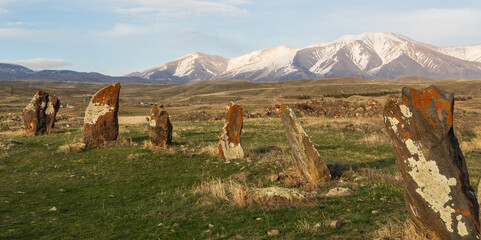 Stones of Zorats Karer in Karaunja in the background of beautiful mountains with snowy peaks....