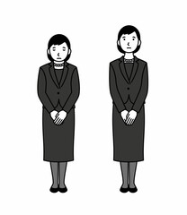お辞儀をする喪服の女性