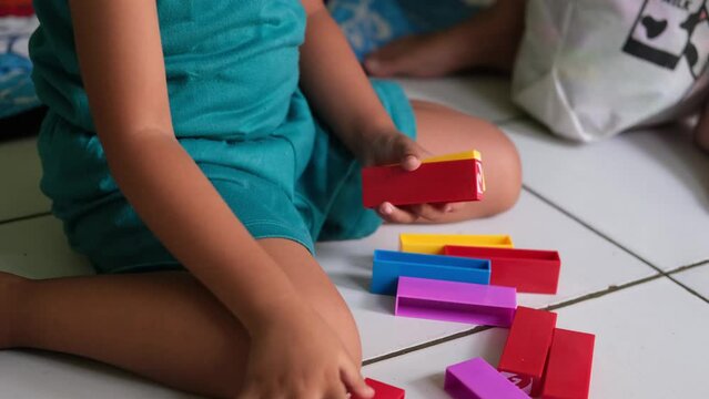 Educational toy blocks. little child playing with colorful toys