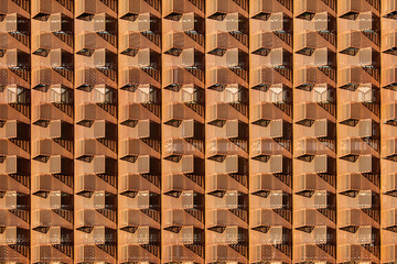 Horizontal Shot of a Rusty Metal Design of a Building's Exterior. Horizontal orientation of a rusty metal design of a building's exterior showing a somewhat crisscrossing pattern.
