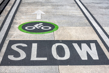 Warning sign Slow for cyclists in a dedicated cycle lane in a heavily traffic area