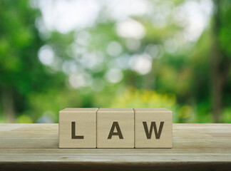 LAW letter on wood block cubes on wooden table over blur green tree in park, Frequently asked...