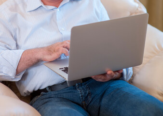 old man use laptop at home.technology business media internet concept.horizontal banner
