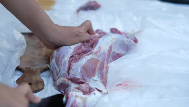 Close-up video of raw meat cutting with a knife. eid adha qurban