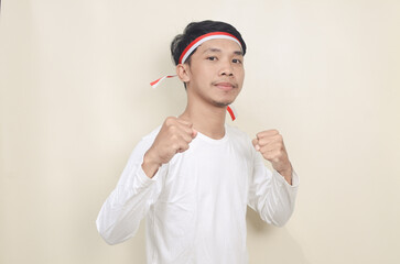 Indonesian man clenched both fist showing excitement when celebrating independence day
