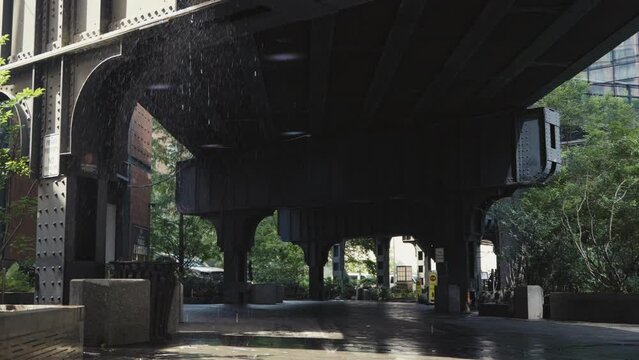 Water dripping from a railway underpass in New York, slow motion.