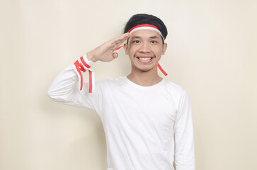 asian man in white shirt wearing red and white ribbon on his head celebrating independence