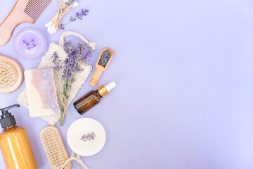 Natural bath accessories and self-care products for body and skin care over purple background with copy space for text. Natural lavender cosmetics kit, eco living concept. Flat lay style © Iryna Mylinska