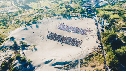 Aerial View People around Parangkusumo sand dunes are praying Eid al-Fitr in the morning