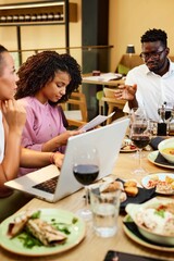 Multicultural businesspeople are having business dinner and brainstorming in a restaurant.
