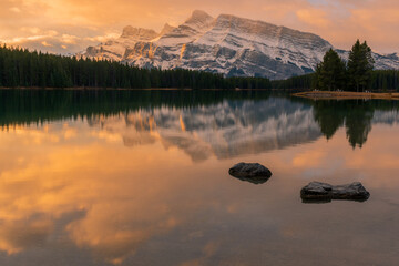 Sunset and mountain reflections in water over Two Jack Lake , Banff National Park, Alberta, Canada