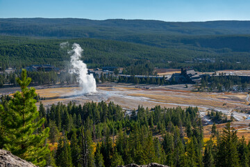 Landscape seen from observation point when famous Yellowstone geyser Old Faithful erupting  