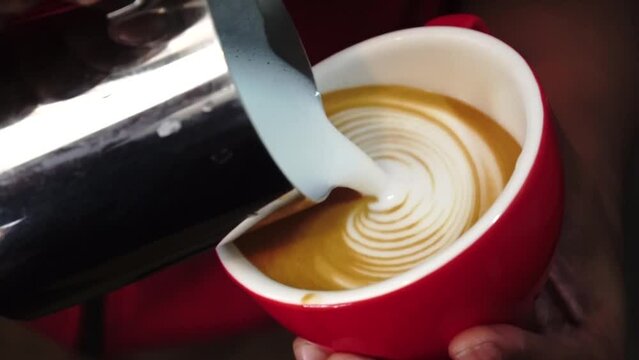 barista pouring latte art pattern, pattern latte art, latte art, barista at coffee shop