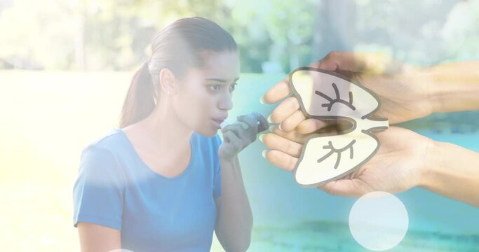 Animation of hands with lungs over biracial woman with inhaler - Powered by Adobe