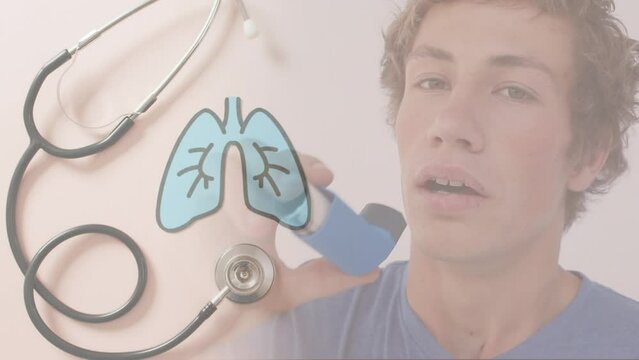 Animation of caucasian man with inhaler over lungs and stethoscope - Powered by Adobe