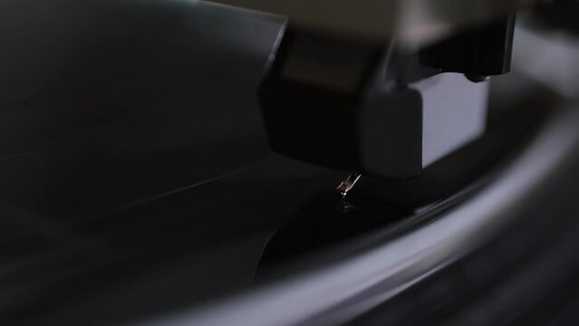 Focus on Stylus of Headshell of Classic Vintage Vinyl Record Player Playing on Vinyl Record Music
