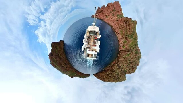 HYPER-LAPSE: tiny planet view of a boat in badlands Calanques of Piana. Aerial view on cruise ship in Corsica badlands called Les Calanches in Mediterranean sea.