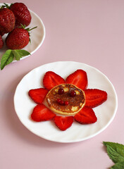 children's breakfast of cottage cheese pancake and strawberries and lingonberries
