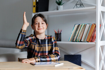 Teen student girl studying and raising hand at school