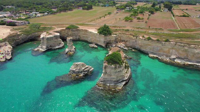 4K aerial of the rock formations of Sant'Andrea near Torre Dell'Orso, Apulia, Italy in the summer.