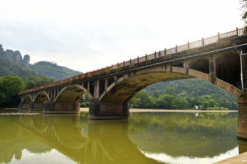 a traditional Chinese style arch bridge on the river