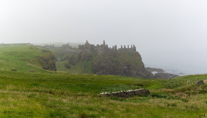 Fototapeta na wymiar view of Dunluce Castle in thick fog on the Causeway Coastal Route