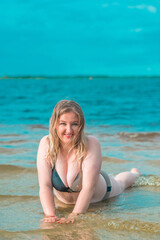 Fototapeta na wymiar Plus size European or American smiling woman at beach, enjoy the life. Life of people xxl size, happy nice natural beauty woman. Concept of overweight