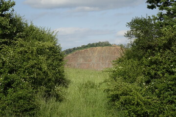 Northern Palatinate landscape with green bushes and surface mining, blue spring sky (horizontal), Pfeffelbach, Kusel, RLP, Germany