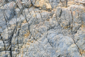 some weathered eroded cracked rocks on the coastline
