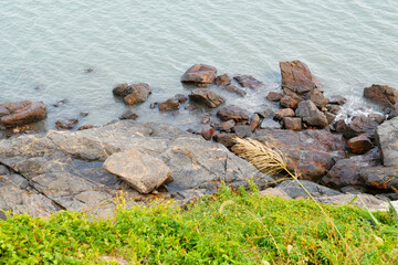 some weathered eroded cracked rocks on the coastline