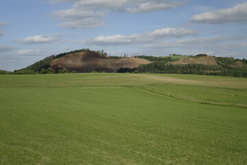 Northern Palatinate landscape with green meadow and surface mining, blue spring sky, concept: outdoors, hiking, industrial (horizontal), Pfeffelbach, Kusel, RLP, Germany