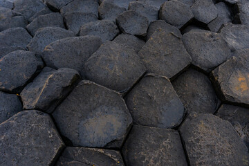 close-up detail view of the volcanic hexagon basalt rock columns of the Giant's Causeway in...