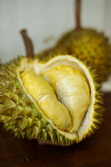 The Durian fruit cut open to reveal fleshy inside. Durian is known as the king of fruit in Asia...
