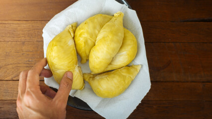 The Durian fruit cut open to reveal fleshy inside. Durian is known as the king of fruit in Asia which has a sweet and delicious taste