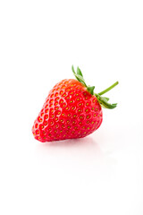 Fresh organic strawberries on a white reflective surface. Close up shot.