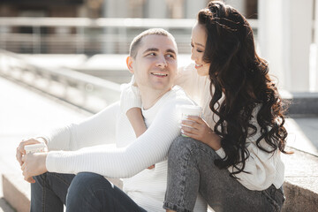 Adorable multiracial couple outdoors. Young people have a date. Woman and man happy together.